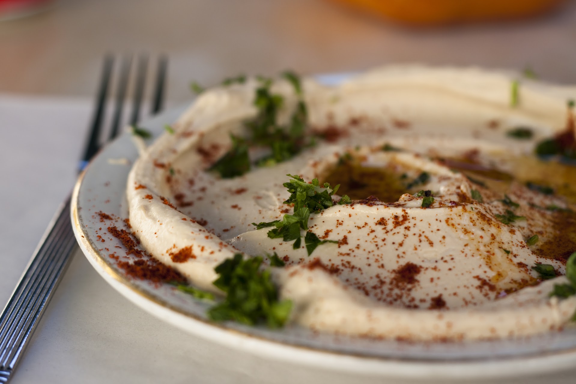 Traditional Middle Eastern appetizers and mezze platter featuring fresh hummus and accompaniments